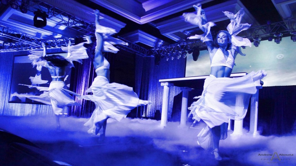 hree girls in white dresses onstage during a magician's performance at Prudential International Insurance Conference at the Manchester Grand Hyatt, San Diego, California.