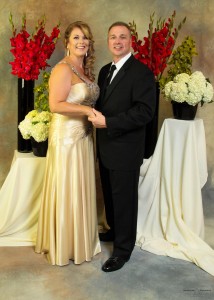 Posed Onsite Event and Portrait Background Ideas - hand painted backdrop with red gladiola bouquets on draped pedestals with couple - AbounaPhoto--8