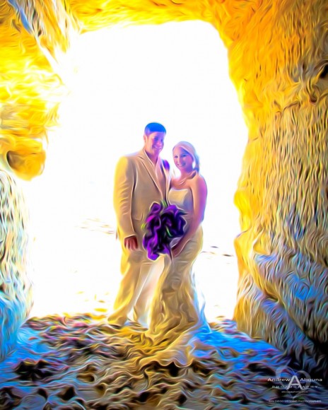 Bride and Groom in back lit sea cave with purple bouquet by San Diego Wedding Photographer Andrew Abouna