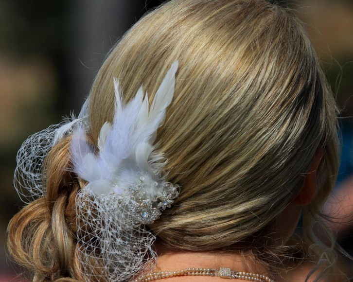 Bride with strawberry blonde wedding hair style and feather and hair accessory by San Diego Wedding Photographer Andrew Abouna